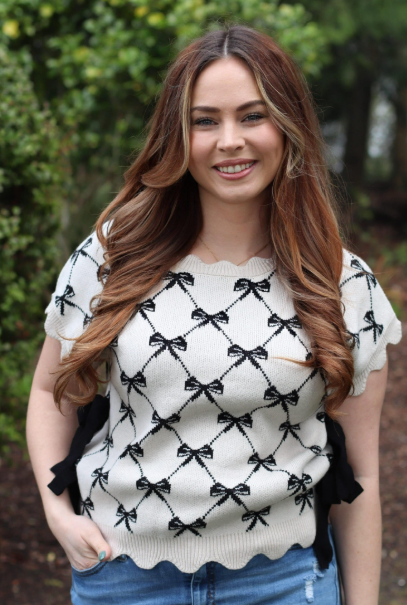 Cream and black bow patterned knit top
